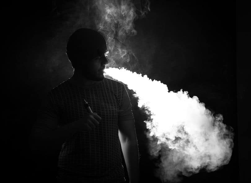 Man with beard vaping