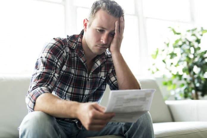 Shocked man having financial problems