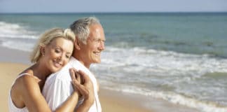Why You Should Retire by the Beach older couple at the beach