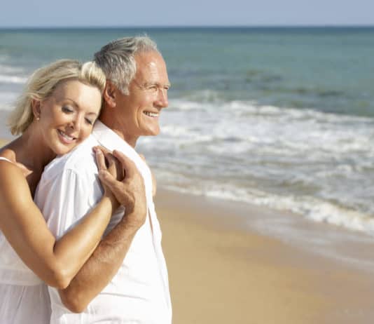 Why You Should Retire by the Beach older couple at the beach